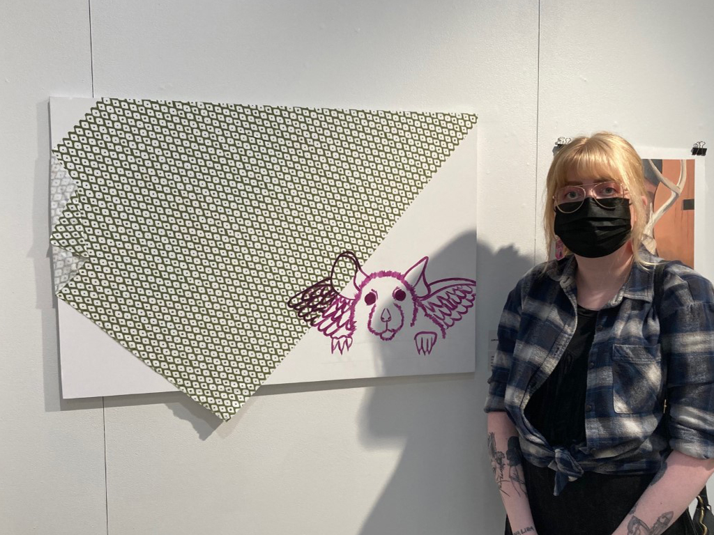 Jess Hodges in front of her jurors choice award winning painting  4 Walls and I